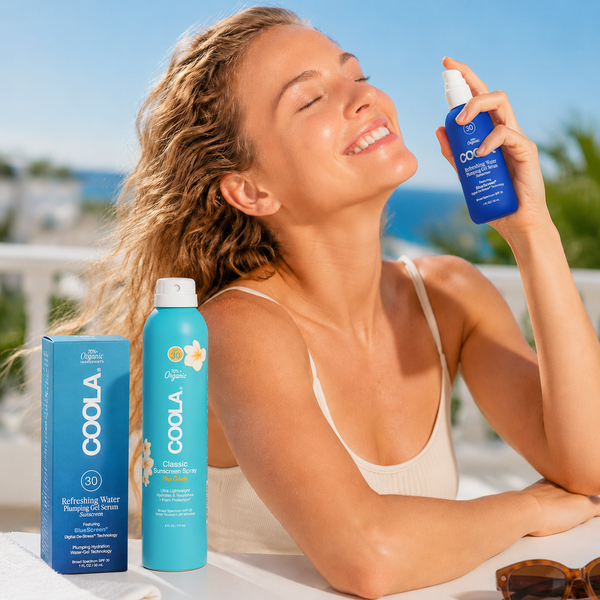 COOLA SPF30 sunscreen spray and Refreshing Water Plumping Gel Serum with woman applying face sunscreen in the sun