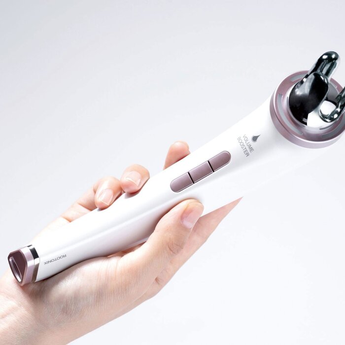 Hand holding a white electronic device with a purple accent on a light gray background