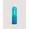 A bottle of COOLA Body Continuous Spray with SPF 50, labeled as fragrance-free, organic, and reef-safe.