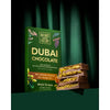 Green box of Natures Own Factory Dubai Chocolate with chocolate bars on a dark green background