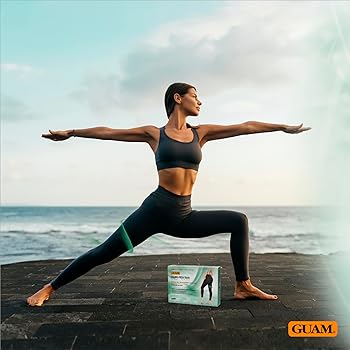 Woman in yoga pose with a Guam product box on a beach