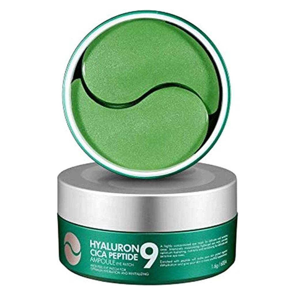 A container of MEDIPEEL Hyaluronic Cica Peptide 9 Ampoule Eye Patch with one patch partially removed from the container, showing a green hydrogel patch with black and white design elements.