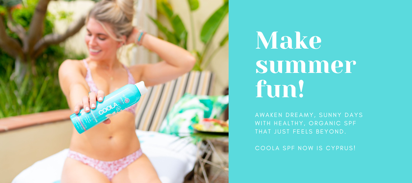 Model holding Coola SPF product for a fun-filled summer in Cyprus