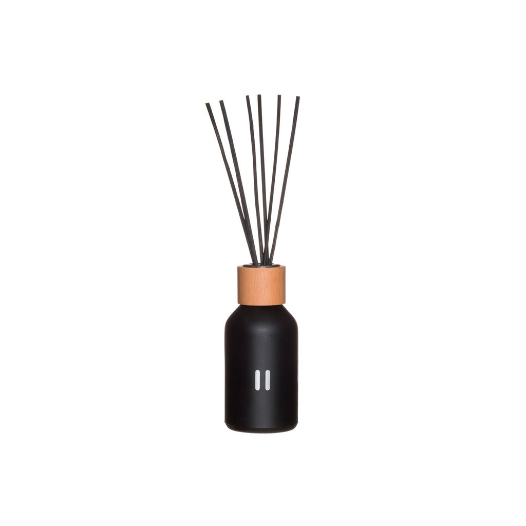Black diffuser bottle with wooden cap and black sticks on a white background