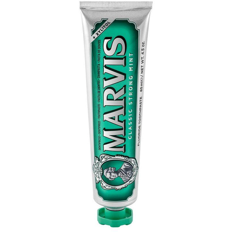 A tube of Marvis Classic Strong Mint toothpaste with a green label and white branding text.