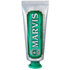 A tube of Marvis Classic Strong Mint toothpaste with a green label and white branding text.